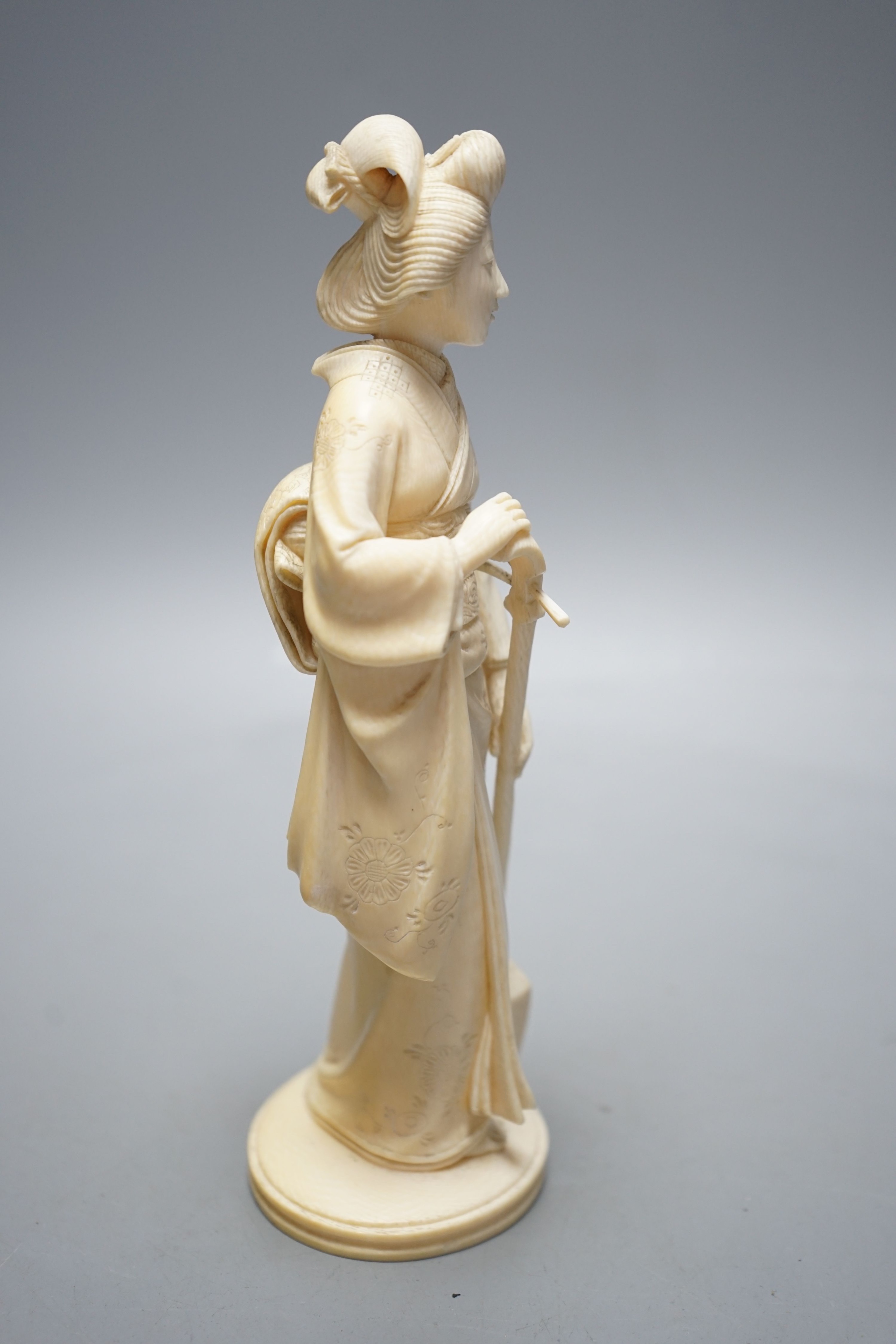 A Japanese Meiji period okimono of a lady with a musical instrument, 19 cms high.
